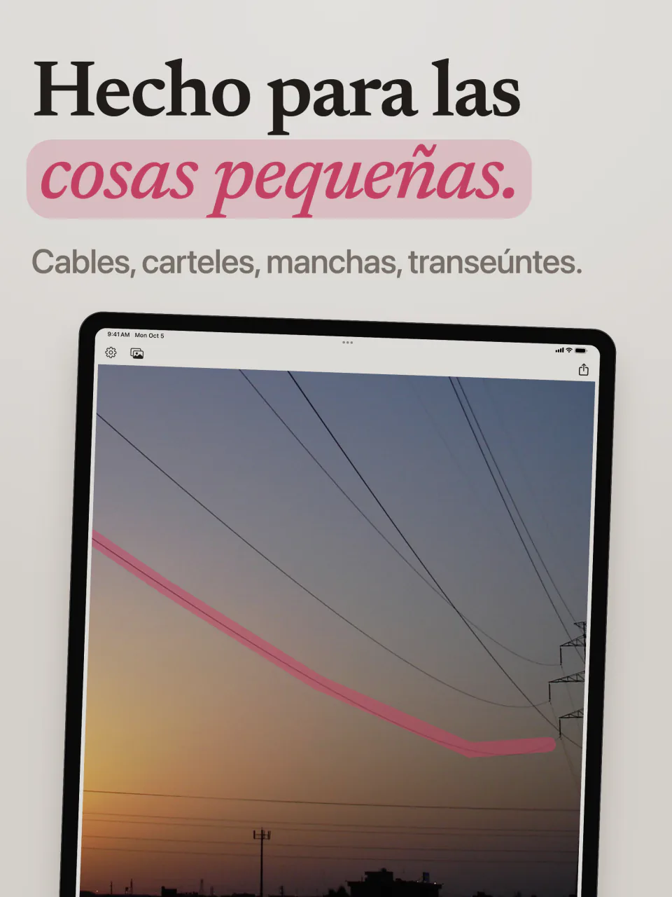 Mend en iPad con un trazo rosa a lo largo de un cable eléctrico que cruza el cielo del atardecer